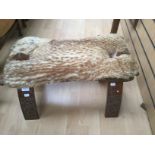 Asian carved stool with fur seat pad.