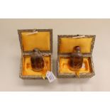 A pair of Chinese snuff bottles, boxed, intricately depicting fishing and port scenes A/F
