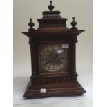 A late 19th Century German mahogany mantle clock, silvered and brass face with Roman numerals