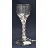 An 18th century opaque twist wine glass, the ogee bowl on double strand and lattice corkscrew core