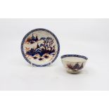 A Liverpool polychrome tea bowl and saucer, decorated with an oriental landscape scene in under-