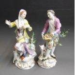 A pair of Meissen figures of a shepherd and shepherdess, he standing hold a birds nest in his hat