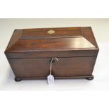 A Regency rosewood tea caddy of sarcophagus form, inlaid mother of pearl flower, side ring