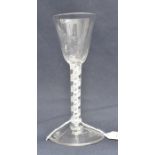An 18th century opaque twist wine glass, the conical bowl, half fluted to the lower section, on a