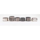 Six assorted silver/white metal napkin rings