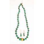A malacite bead necklace, comprising round graduated beads with alternate gilt metl bead spacers,