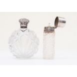 A silver topped perfume bottle with stopper Birmingham 1900 and another with a white metal top and