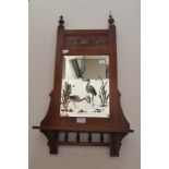 A pair of Victorian wall hanging shelved mirrors with water scenes painted on glass