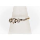 A three stone diamond ring, illusion set with three graduated diamonds set in platinum, 18ct gold