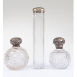 Three silver topped perfume dressing table glass bottles