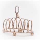 A silver plated toast rack, bearing military bearings