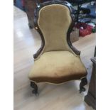 A Victorian mahogany ladies chair upholstered in gold velvet.