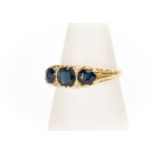 A Victorian sapphire and diamond ring, comprising three round sapphires, with diamond accents, 18 ct