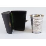A German silver beaker in a leather travel case embossed cherub pattern gilt interior 800 stamped
