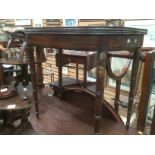 A 19th Century mahogany folding tea table on turned tapered supports