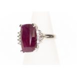 A ruby and diamond dress ring, the claw set cushion cut ruby measuring approx 16mm x 10mm, four