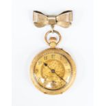 An 18ct gold ladies open faced pocket watch, gold tone dial, numbers, subsidiary dial, scroll and