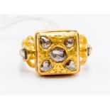 A diamond set ring, comprising ethnic decoration, 18ct gold, square mount set with rose cut diamonds