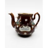 A Measham 'Barge' teapot with the name "T Stinson Station Road Coalville" stamped on an applied