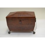 A Regency amboyna tea caddy, of sarcophagus form, double division interior, ring side handles, brass