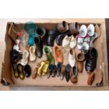 A collection of ornamental shoes and boots, including ceramic, crested ware, pin cushions, pottery