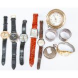A group of assorted wristwatches together with a silver Mercedes travel clock, two silver napkin