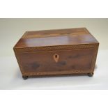 A Regency yew wood tea caddy of sarcophagus form, parquetry inlaid, triple division interior, side