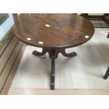 A 20th century oak tripod coffee table