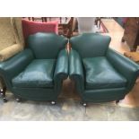 A pair of 20th century fine leather armchairs on brass castors (2)