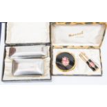 A pair of Art Deco clothes brushes, boxed; and a Mascot compact and atomiser set, boxed (2)