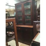 A Victorian mahogany bookcase with glazed upper section on a base with two drawers and two
