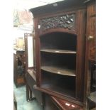 A late Victorian carved wall hanging corner open bookcase, circa 1890