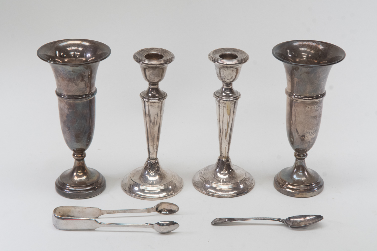 Two silver candlesticks, London 1920 and two spill vases, Birmingham 1960 with a teaspoon and plated