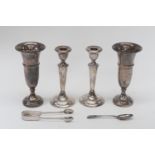 Two silver candlesticks, London 1920 and two spill vases, Birmingham 1960 with a teaspoon and plated