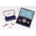 A Victorian silver target brooch and a pair of earrings en suite, applied floral leafage motifs in