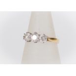 A diamond three stone ring, the three claw set round brilliant cut diamonds weighing a total of