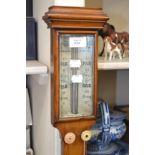 A 19th Century T. Underhill oak mercury stick barometer with ivory gauge, thermometer below