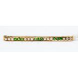 An emerald and seed pearl bar brooch, comprising alternate rows of pearls and emeralds, width approx