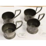 A set of 4 petwer beaker holders with shield design decoration (4)