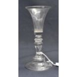An 18th century wine glass, probably Continental, the flared trumpet bowl on knopped inverse