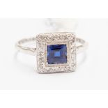 A sapphire and diamond cluster ring, the square cut sapphire weighing approx 0.90ct, diamond set