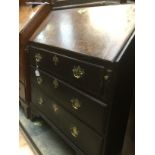 A George II oak bureau, circa 1750, the fall opening to reveal a fitted interior, three long