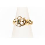 An early Victorian seed pearl and green stone set ring, possibly emerald, scroll mount, unmarked