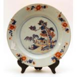 An 18th Century porcelain plate decorated in an Oriental style with cobalt blue and iron red, the