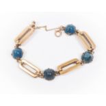 A 9ct gold blue agate set bracelet, alternate dome shaped stones with alternate open elongated