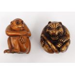 Two wooden Japanese carved netsukes one depicting a seated monkey, the other a Zodiac Foo dog(2)