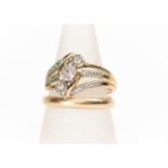 A 9ct gold and diamond set dress ring, cross over design, with three diamond cluster details set