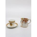 An Armorial cup and saucer "E.D 1881" in gilded decoration, with a Victorian Tyg. (3) size: Cup -