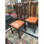 A set of four early 20th century oak leather seated side chairs (4)