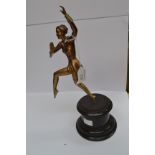 An Art Deco Spelter figure of a lady dancing raised on a black base, 30 cms high approx